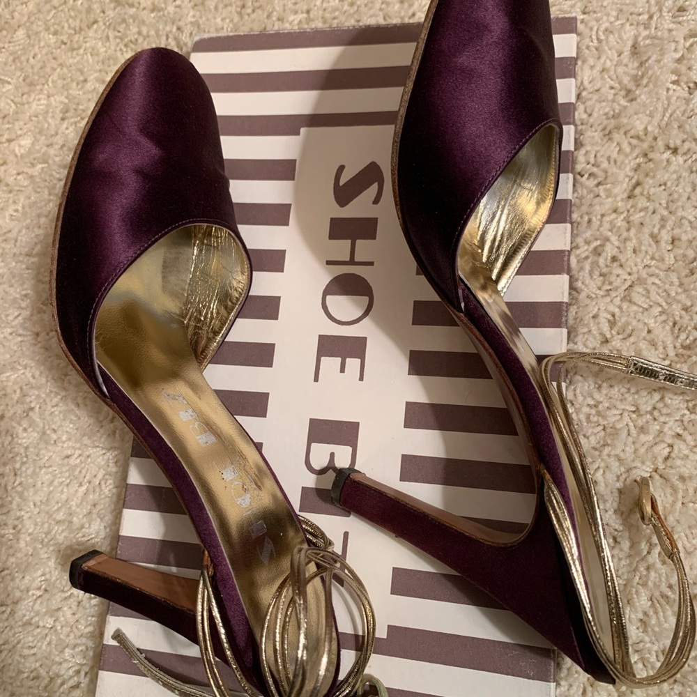 Purple satin evening shoes with gold ankle straps.